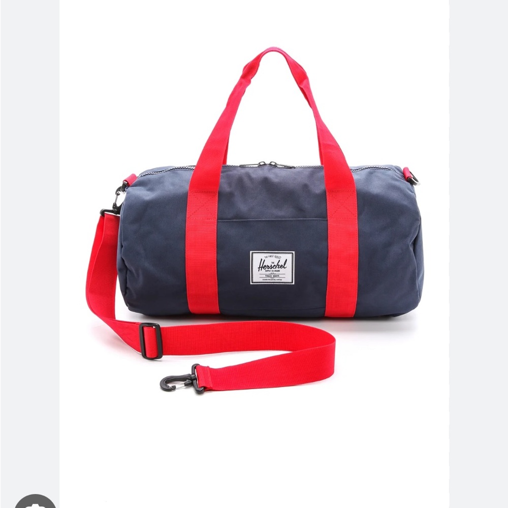 Herschel Supply Strand duffle. Navy blue canvas with red nylon strap.